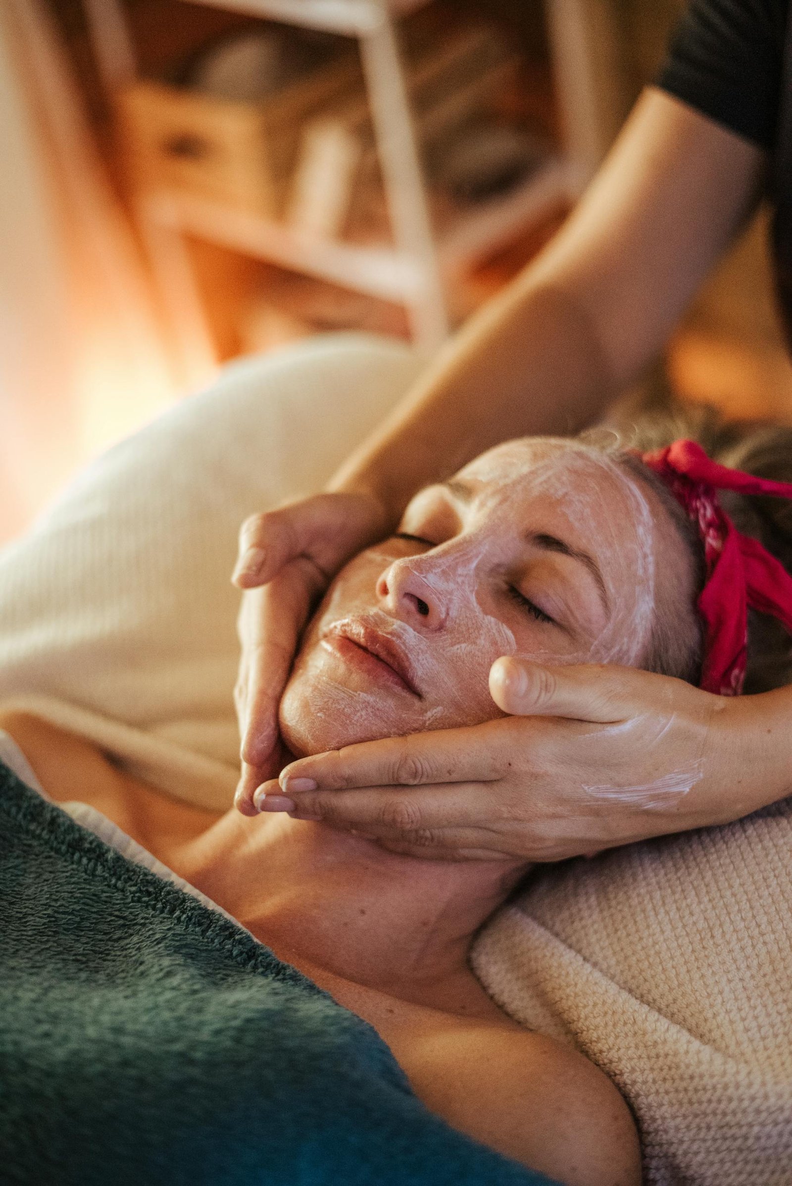 A woman enjoys a calming facial treatment, highlighting spa wellness.